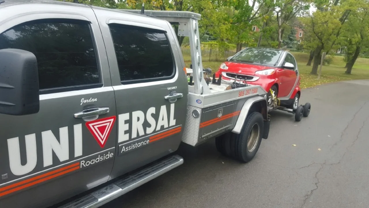 Universal Roadside Assistance tow truck transporting a vehicle in Hamilton